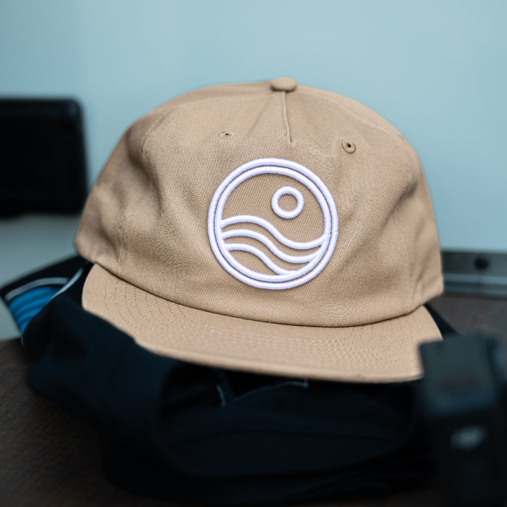 Beige cap with a logo on a blurred background