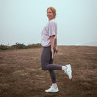 Person standing on a grassy field with a plain background
